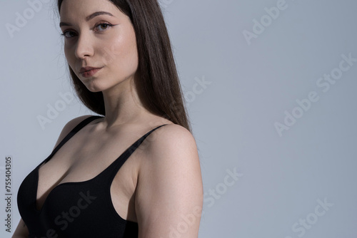 Close-up portrait of attractive sexy Caucasian young brunette woman in studio. Luxury, elegance, fashion.