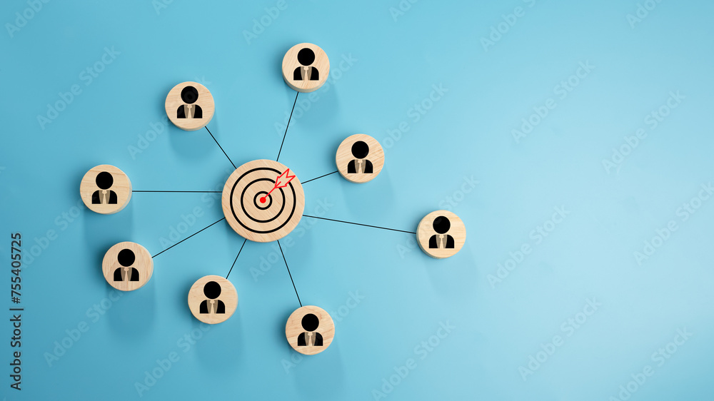 Obraz premium Circular wood with printed target icons and business symbols on light blue background, business goals and objectives concept, business competition, Customer relationship management concept.