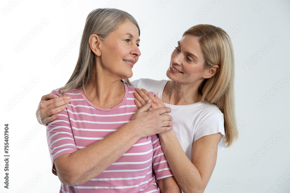 Mother and daughter holding hands while standing close Mother and daughter holding hands while standing close
