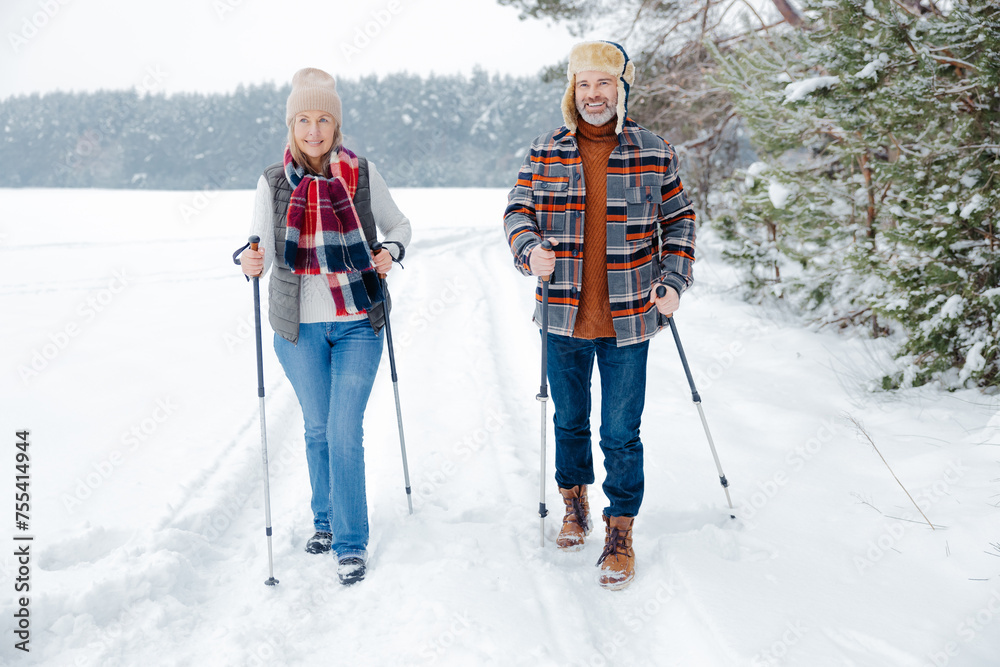Couple on a walk with scandinavian sticks