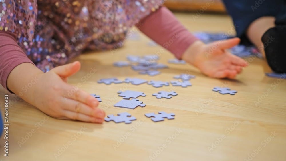 Caucasian Preschooler Girl Playing With Jigsaw Puzzle Pieces Scattered on a Floor Caucasian Preschooler Girl Playing With Jigsaw Puzzle Pieces Scattered on a Floor