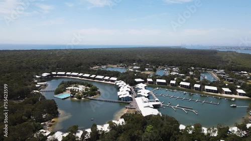 Aerial view of Couran Cove on South Stradbroke Island with the Gold Coast skyline in the distance. Panning drone view photo