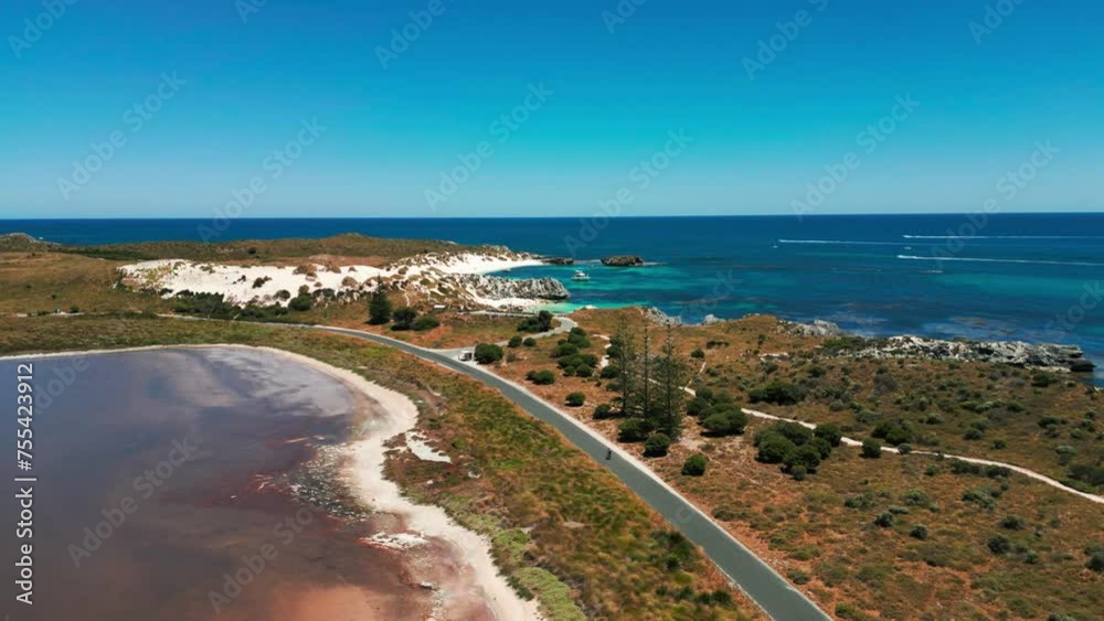 aerial view of coastal road on rotness island with a bicycle riding on a sunny day, western australia aerial view of coastal road on rotness island with a bicycle riding on a sunny day, western australia