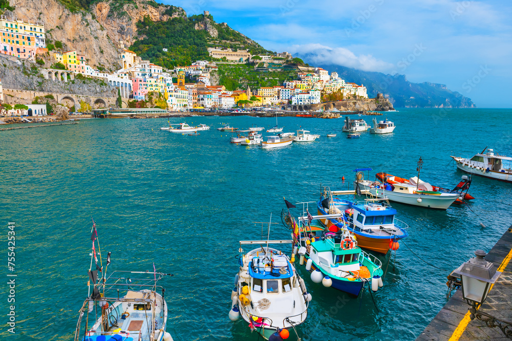 Amalfi coast, Italy. Beautiful view of Amalfi town and pier with fishing boats.