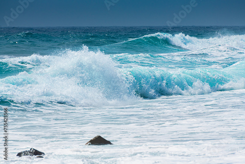 Waves on the beach in windy day. Blue sea and the blue sky. photo