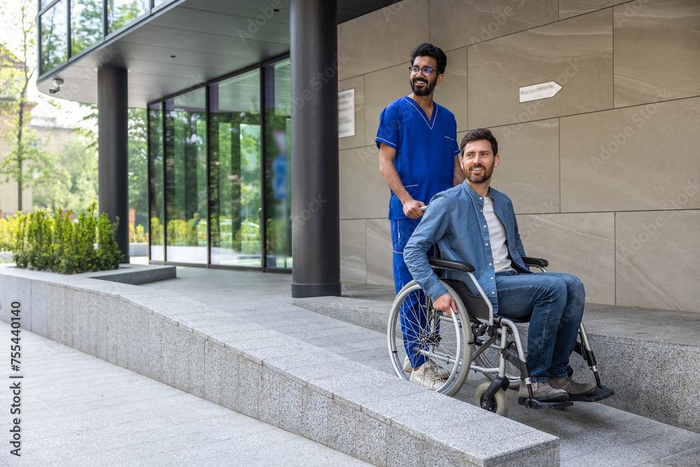 Hospital patient in a wheelchair with a male nurse