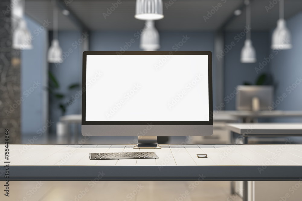 Creative designer desk with empty white mock up computer display, supplies and blurry office interior in the background. 3D Rendering.