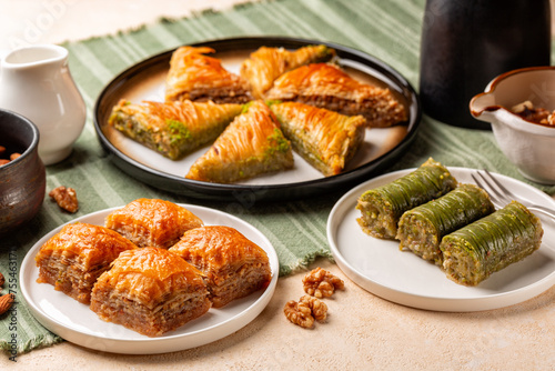 Sweet table with Baklava, layered pastry dessert made of filo pastry sheets, filled with chopped nuts, with honey. Middle Eastern, Arabic, Turkish, Ramadan desserts. Selective focus.