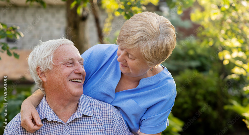 Happy senior man spending leisure time with woman in garden Happy senior man spending leisure time with woman in garden