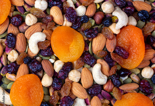 Mix of nuts and dried fruits isolated on a white background. © Esin Deniz