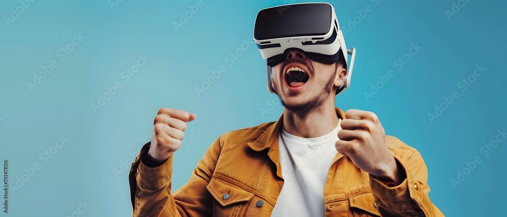 Excited Man using VR or virtual reality glasses isolated on blue background, with hands holding up on air trying to exploring metaverse, futuristic technology concept. copy space. Excited Man using VR or virtual reality glasses isolated on blue background, with hands holding up on air trying to exploring metaverse, futuristic technology concept. copy space.