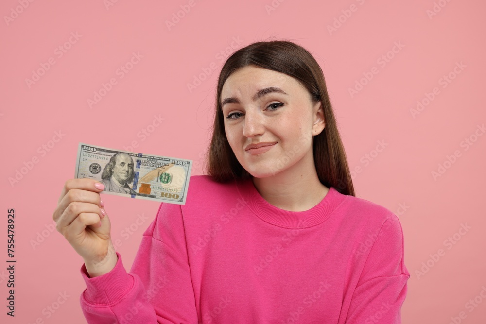Sad woman with dollar banknote on pink background Sad woman with dollar banknote on pink background