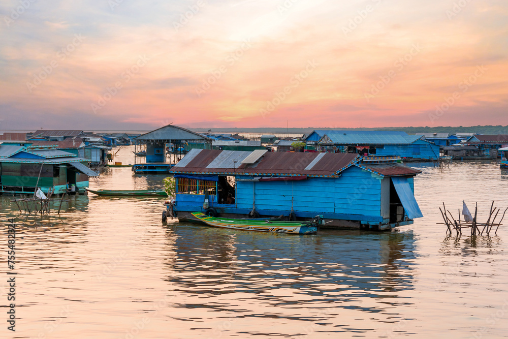 Village on the water of Tonle Sap lake in Cambodia. Beautiful lighting, sunset.
