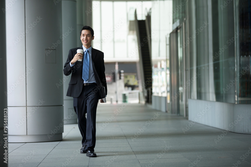 Chinese businessman walking in the city. Chinese businessman walking in the city.