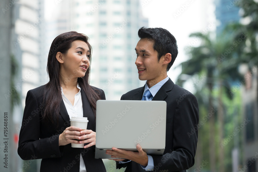 Asian business people working together on a laptop Asian business people working together on a laptop