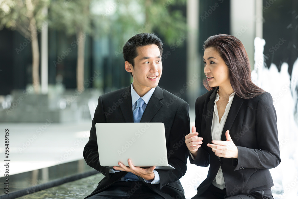 Asian business people working together on a laptop Asian business people working together on a laptop