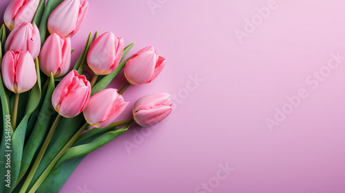 A bouquet of pink tulips on a colored table background #755489908
