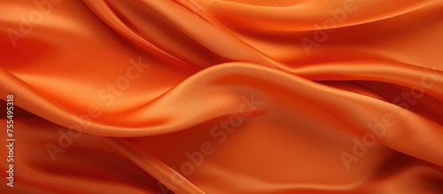 This close-up shot showcases the intricate texture and vibrant color of an orange fabric. The details of the fabric are highlighted, revealing the weave pattern and thick threads.
