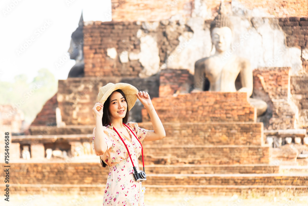 Girl visiting Ayutthaya Thailand at Wat Mahathat, women with a hat and tourist map visiting Ayutthaya Thailand.