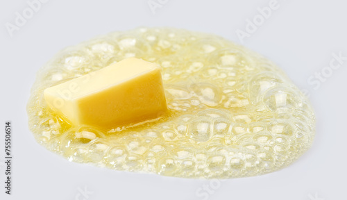 Butter melting over grey background