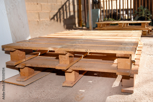 Wooden supports for moving and transporting goods. Warehouse pallet for moving goods. Paleta  Estiba or tarima in the factory territory