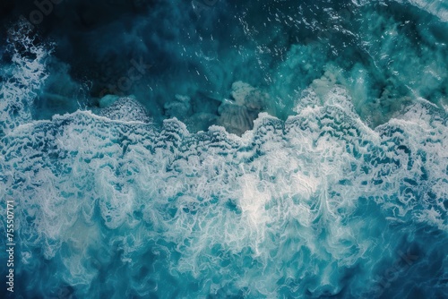A large wave crashing into the ocean. The water is a deep blue color, and the wave is very large. Scene is powerful and awe-inspiring