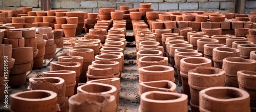 The room is filled with a vast array of clay pots of various sizes and shapes. The pots are made of brick construction cement, neatly arranged throughout the room.