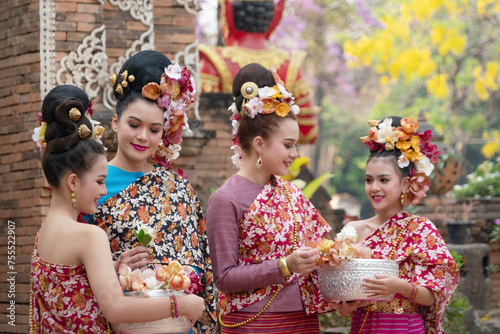 Group of Beautiful Asian woman wearing traditional Thai clothing in Wat Lok Molee During the Thai Songkran.