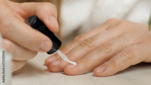 Applying nail polish to the nail. Close-up of a nail brush. Manicure. Beauty care