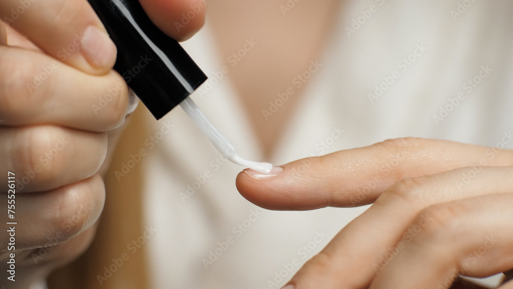 Close-up of applying nail polish on a nail. Nail brush. Manicure. Beauty care