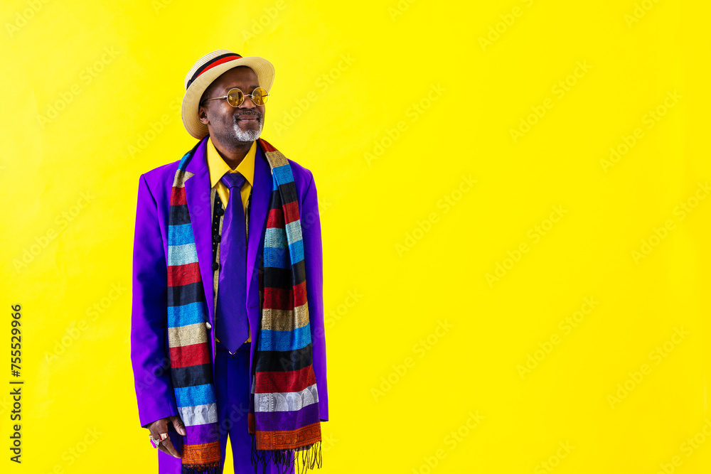 Cool senior black man with fashionable outfit portrait - African old person wearing cool stylish clothing on colorful background