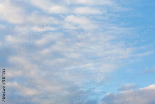 Morning sky. Beautiful fluffy clouds painted in pastel painterly colors at sunrise. Multicolor background or wallpaper