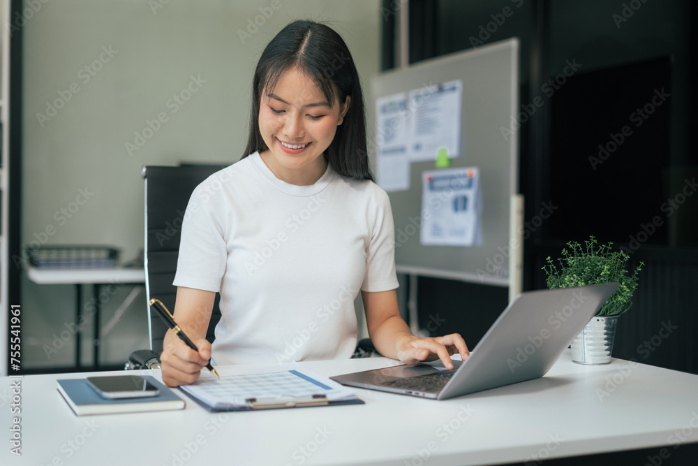 Female writes information businessman working on laptop computer writing business plan while sitting in office. Female writes information businessman working on laptop computer writing business plan while sitting in office.