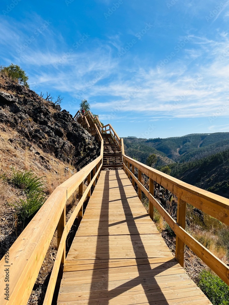 Obraz premium Hiking wooden boardwalk in mountains, hiking trail, wooden stairs