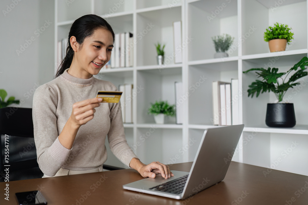 Woman on desk with smartphone, credit card and ecommerce payment for online shopping at home Woman on desk with smartphone, credit card and ecommerce payment for online shopping at home