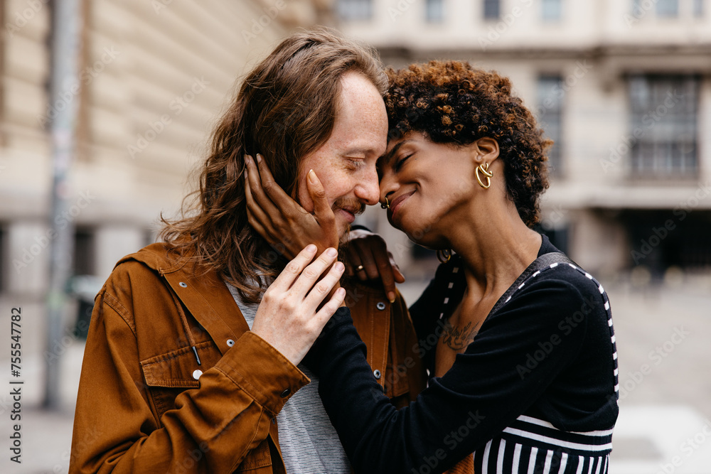 Affectionate embrace on city streets by a loving couple Affectionate embrace on city streets by a loving couple