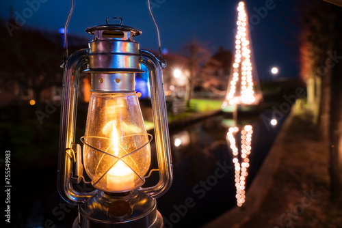 Oil lamp illuminates old character in Ducth village photo