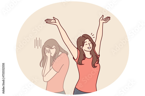 Positive woman raises hands up and rejoices having got rid of bad emotions and depression spoiling mood. Crying doppelganger behind girl for concept of mood swings or split personality
