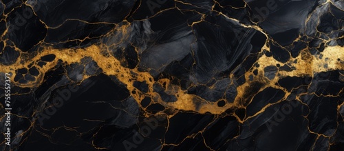 Intricate patterns of black marble with a luxurious gold texture creating a striking contrast. The gold veins weave through the dark background, adding depth and elegance to the design.