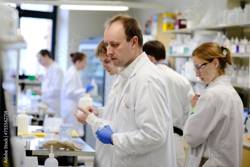 group of scientists working in laboratory  scientists conducting research investigations in a medical laboratory