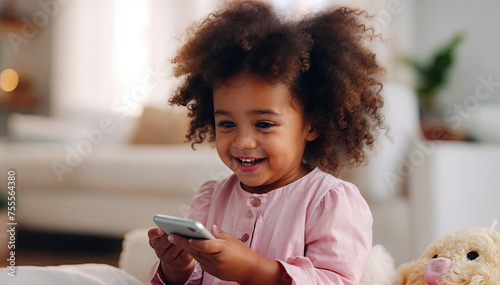 Cheerful african american little girl using smartphone at home