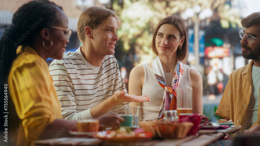 Two Diverse Couples Spending Time Together on a Double Date, Enjoying Delicious Food at an Outdoors Pizzeria. Multiethnic Young Men and Women Having Joyful Conversations, Smile and Laugh at Jokes