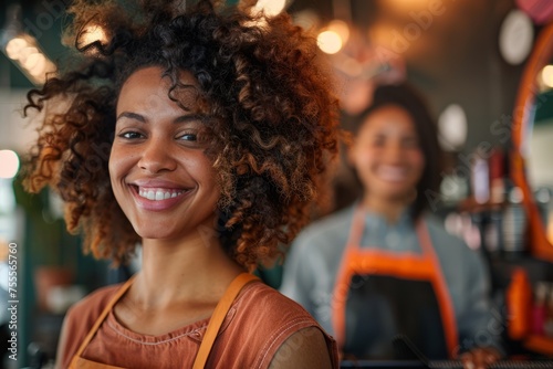 In a vibrant salon, a joyful hairdresser styles a smiling woman's voluminous afro hair, both exuding satisfaction and happiness in a modern beauty care setting.