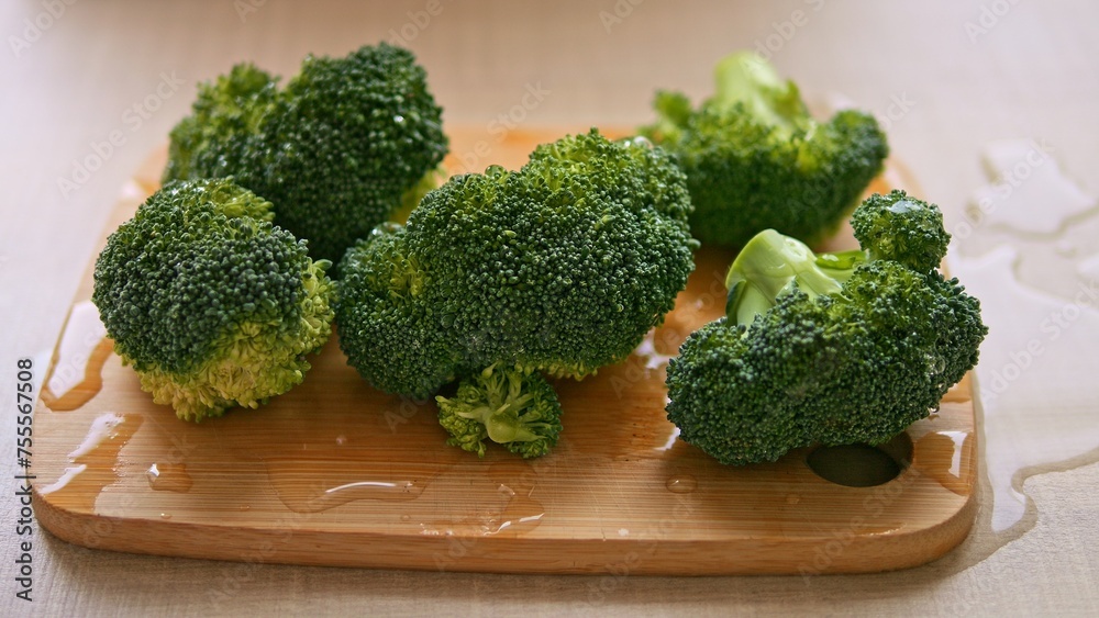 Healthy vibrant green broccoli rests on board ready for preparation exuding freshness Healthy broccoli promises nutritious start to cooking Delight in healthy of broccoli, begin your culinary journey Healthy vibrant green broccoli rests on board ready for preparation exuding freshness Healthy broccoli promises nutritious start to cooking Delight in healthy of broccoli, begin your culinary journey