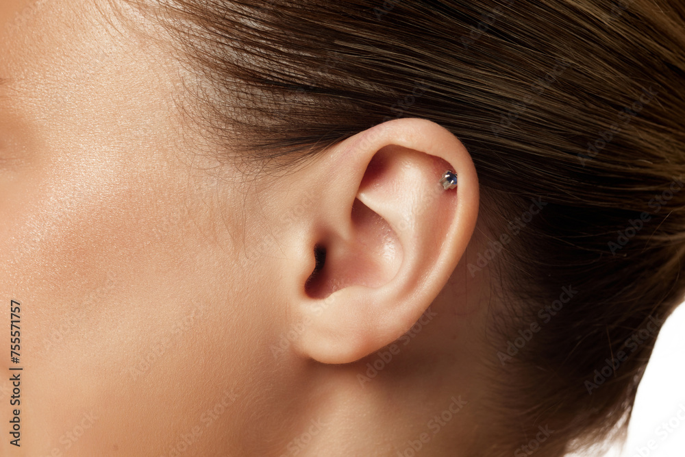 Close up photo of female ear with piercing against white studio background. Plastic injury. Body parts. Concept of natural beauty people, injections, wellness, spa procedures, cosmetology. Ad - obrazy, fototapety, plakaty 
