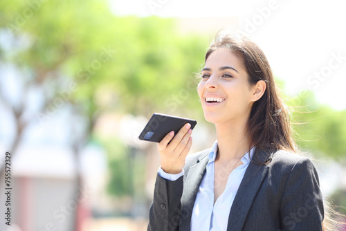 Happy executive dictating message on phone