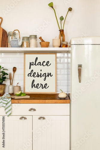Interior design of kitchen space interior with mock up poster frame, fridge, jar with spices, pear, vase with flowers, kitchen board, plant in flowerpot and personal accessories. Home decor. Template.
