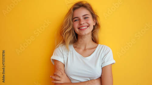 portrait of happy young woman standing with arms folded