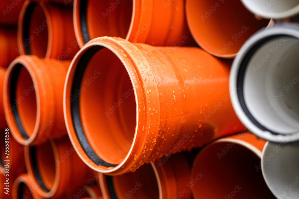 Plastic water pipes stacked outdoor on rainy day Plastic water pipes stacked outdoor on rainy day