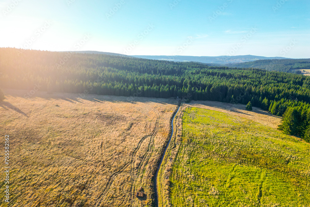 Blatna irrigation canal in the middle of autumn landscape at Ryzovna, Ore Mountains, Czech: Krusne hory, Czechia. Aerial view from drone.